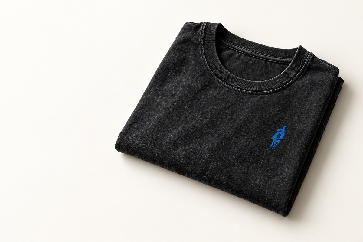 Folded washed-black T-shirt with original rocket chest mark, AI design concept